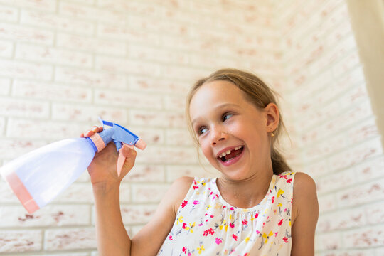 Child spraying water on the face