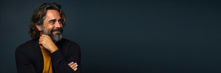 middle age man wearing casual clothes looking to the side in front a blue background. copy space. Banner design with space for text