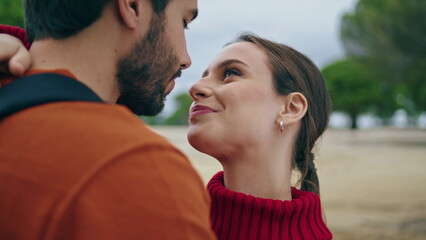 Portrait beautiful couple nature. Happy man kissing smiling woman nose outdoors.