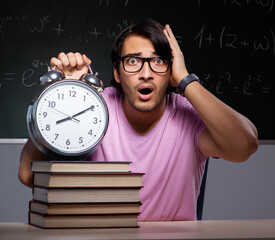 Young male student sitting in classroom