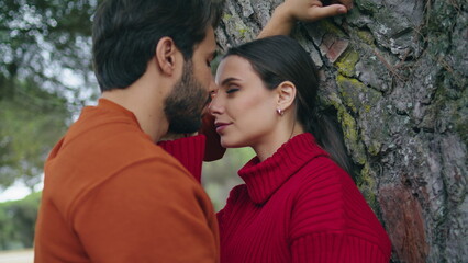 Fototapeta premium Portrait loving romantic couple near tree looking on each other with love.