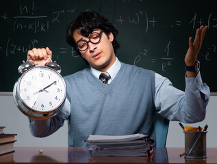Young math teacher in front of chalkboard