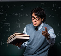 Young math teacher in front of chalkboard