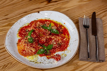 Spinach and ricotta ravioli with tomato sauce and parmesan.