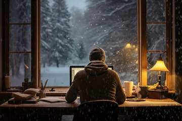 Foto op Canvas A person works from a home office with a view of falling snowflakes outside, finding focus and productivity in the tranquility of an indoor winter workspace © Gbor