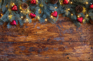 A festive Christmas garland with heart shaped ornaments on a rustic wooden backdrop - 661176686