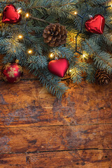 A festive Christmas garland with heart shaped ornaments on a rustic wooden backdrop - 661176808
