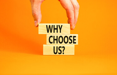 Why choose us symbol. Concept word Why choose us on beautiful wooden block. Businessman hand....