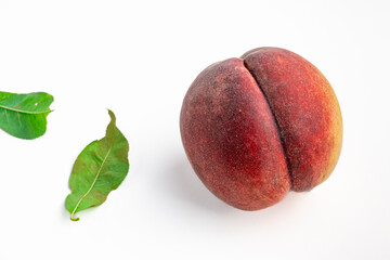 Ripe peach. Whole peach fruits with leaf isolated on white background.