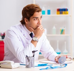 Young male doctor otolaryngologist working at the hospital