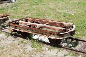 A rusty platform of a narrow-gauge railway carriage