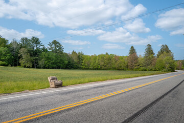 Reclining chair abandoned on side of country road