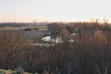 end of the day at the Wieprz river valley during winter season - obrazy, fototapety, plakaty