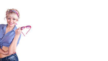 blonde girl in a blue shirt and jeans holds glasses in her hand. Isolated on a white background. Banner. Space for text.