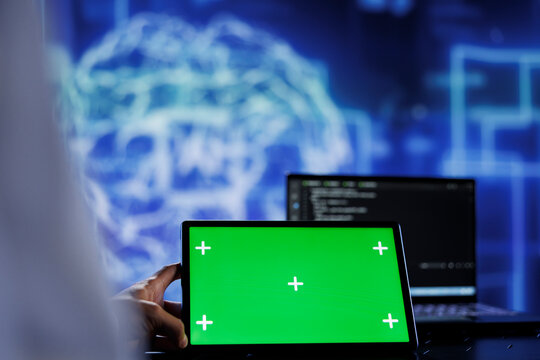 Trained admin writes code on mockup tablet to visualize artificial intelligence neural networks using augmented reality. High tech workspace worker runs AI script on isolated screen device
