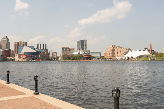 Baltimore, Maryland, US - July 26, 2023: A view of the Baltimore Inner Harbor waterfront from the Promenade at the Ritz Carlton Residences from the National Aquarium to Pier 5 on the right