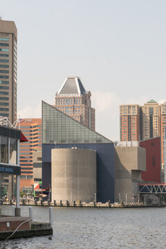 Baltimore, Maryland, US - July 26, 2023: Main building of the National Aquarium in Baltimore seen on its waterfront pier at the Inner Harbor downtown
