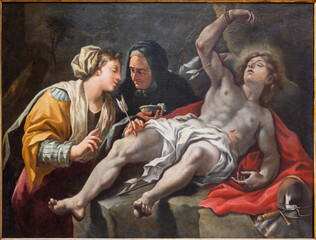 NAPLES, ITALY - APRIL 23, 2023: The painting of Saint Sebastian tended by Saint Irene in the church Chiesa di San Nicola alla Carita by Francesco Peresi (1709 - 1743).