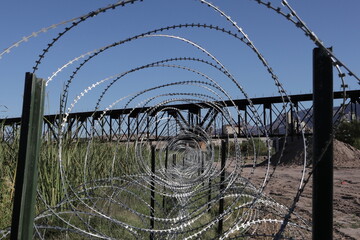 El Paso, TX USA, October 12, 2023 Razor barb wire along Rio Grande to prevent migrants from...