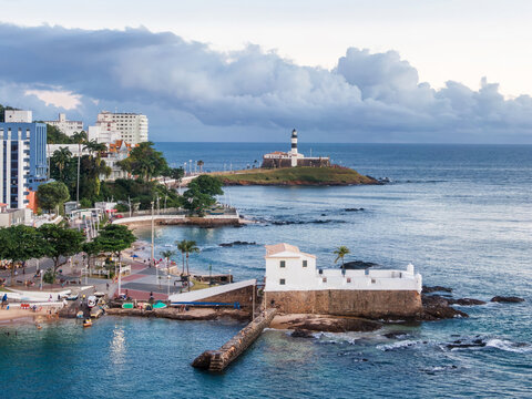 Aerial view of the historic Barra Lighthouse and Santa Maria Fort on the coastline of Salvador da Bahia, Brazil.