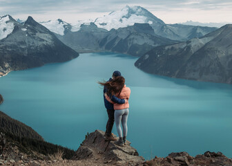 couple in the mountains overlooking glacier lake