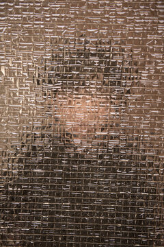 art portrait of boy behind old cracked glass window