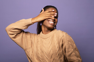 Charming fashionable young black woman 20s wears casual over violet color background