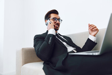 Phone man smile office winner video computer talk call laptop businessman portrait