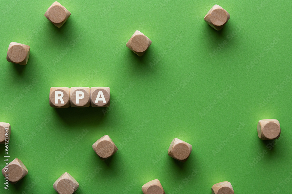 Poster there is wood cube with the word rpa. it is an abbreviation for robotic process automation as eye-ca