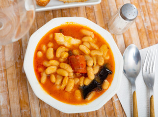 Delicious Fabada asturiana with stewed beans, pork, morcilla and chorizo. Famous authentic regional...