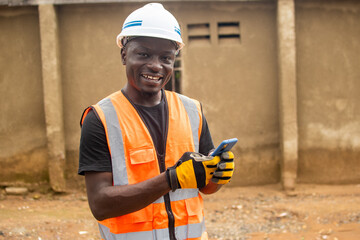young african engineer using his phone