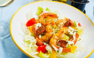 Seafood salad with shrimps, lettuce leaf, tomatoes and lemon