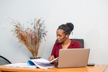 beautiful young african lady busy with work in her office