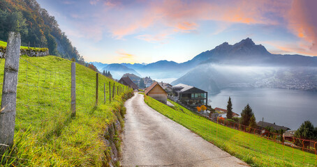 Captivating autumn view on suburb of Stansstad city and Lucerne lake with mountaines and fog - obrazy, fototapety, plakaty
