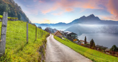 Fototapete Alpen Captivating autumn view on suburb of Stansstad city and Lucerne lake with mountaines and fog