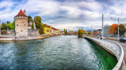 Fabulous historic city center of Lucerne with famous buildings and calm waters of Reuss river.
