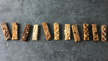 Various Granola bar on Cement Table Background