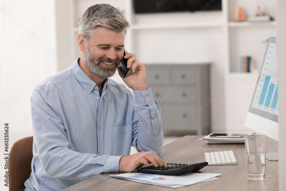 Sticker Professional accountant talking on phone and working at wooden desk in office