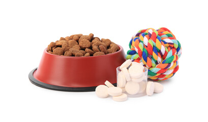 Dry pet food in bowl, vitamins and toy isolated on white