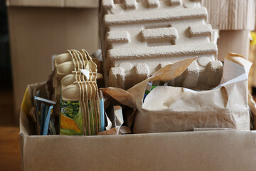 Reuse concept. Different trash in cardboard boxes for recycling indoors