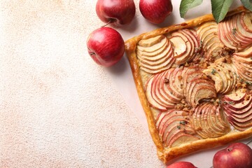 Tasty apple pie with nuts and fresh fruits on beige textured table, flat lay. Space for text