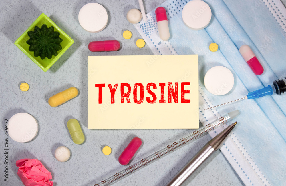 Poster notepad with the text and chemical structure of l tyrosine on table with pills stethoscope.