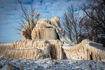 thick Ice formations over the monument  after ice winter storm on the lake, winter wonderland