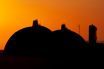 Silhouette of San Onofre nuclear power plant main reactors at sunset