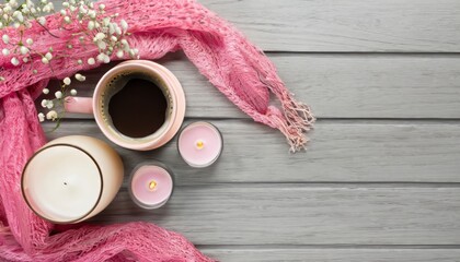 Top view cup of fresh coffee on saucer gypsophila flowers stylish glasses candles and pink scarf on wooden background