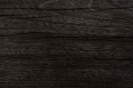 Dark brown neutral wood background was used for the design texture wallpaper and copy space, The natural wood grain has cracked due to age. vintage beauty