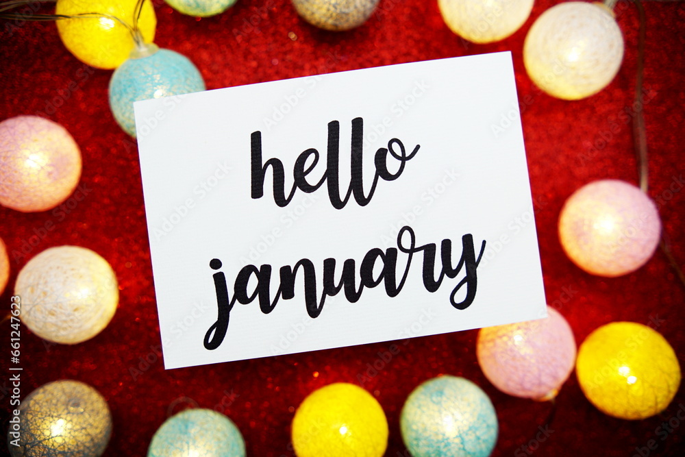 Poster hello january text on paper card top view on red bokeh background