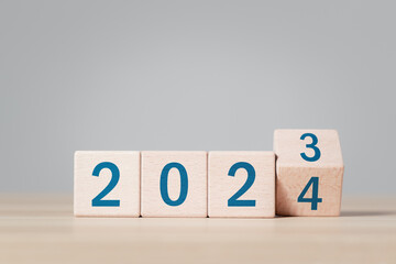 2024 growth business. wooden block with 2023 change to 2024, setup objective target business cost...