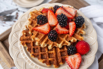 Protein healthy waffles, with berries, on a cream plate for  breakfast