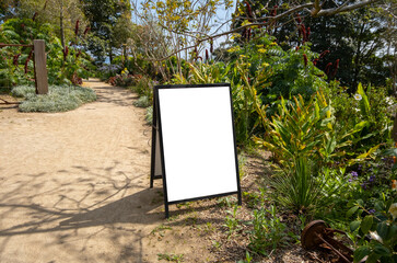 Blank white mockup template background texture of a sign board placed in an rural outdoor garden....